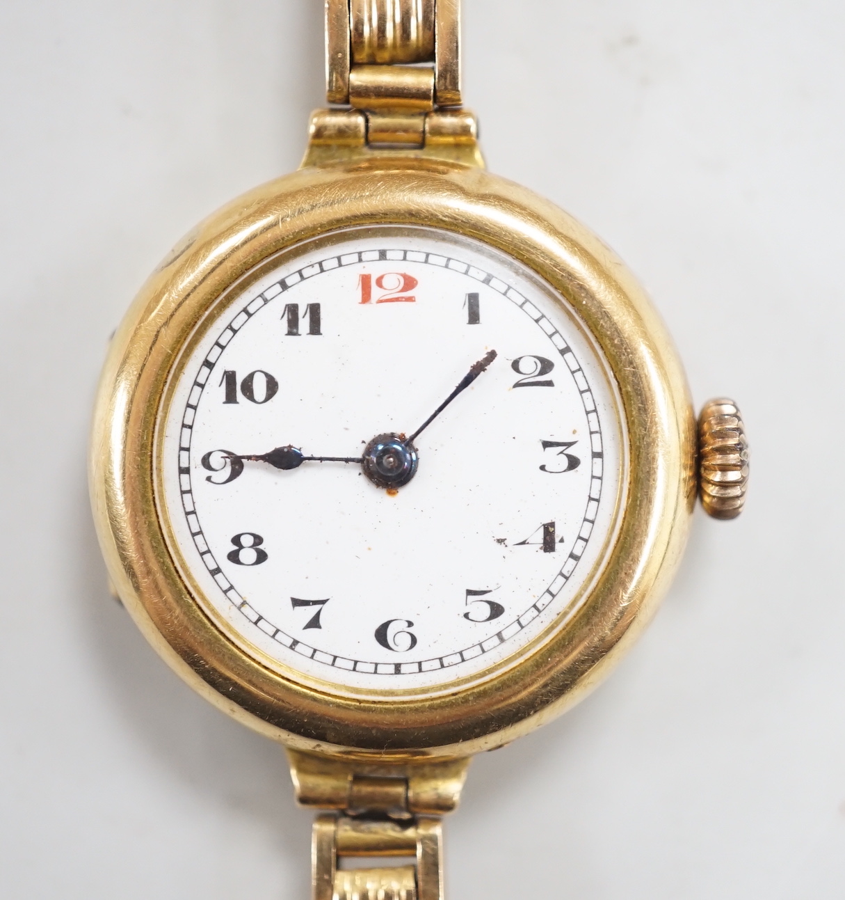 An early 20th century 18ct gold manual wind wrist watch, on an 18ct flexible bracelet, case diameter 25mm, gross weight 25.9 grams.